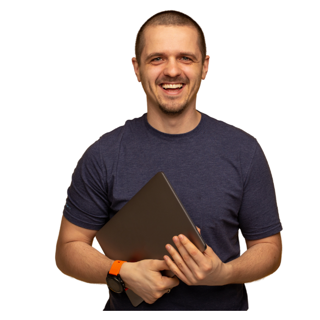 a man holding a laptop and smiling